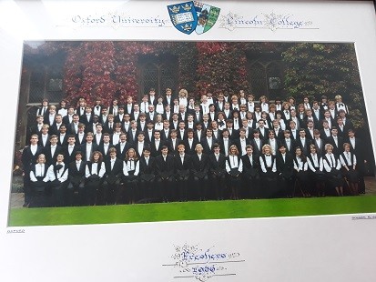 A formal photograph of students in front of an old college building in Oxford